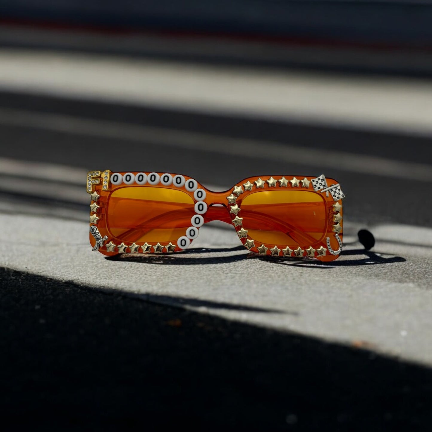 Orange rectangle frame and lens sunglasses with gold stars