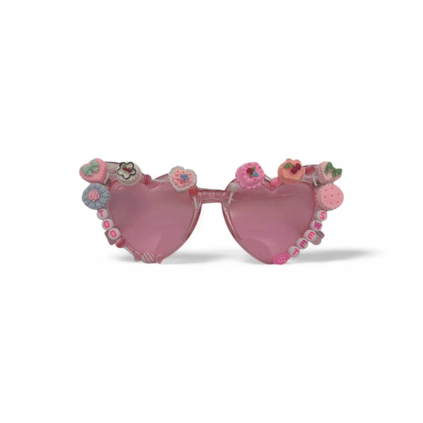 Pink heart sunglasses with cakes and candies