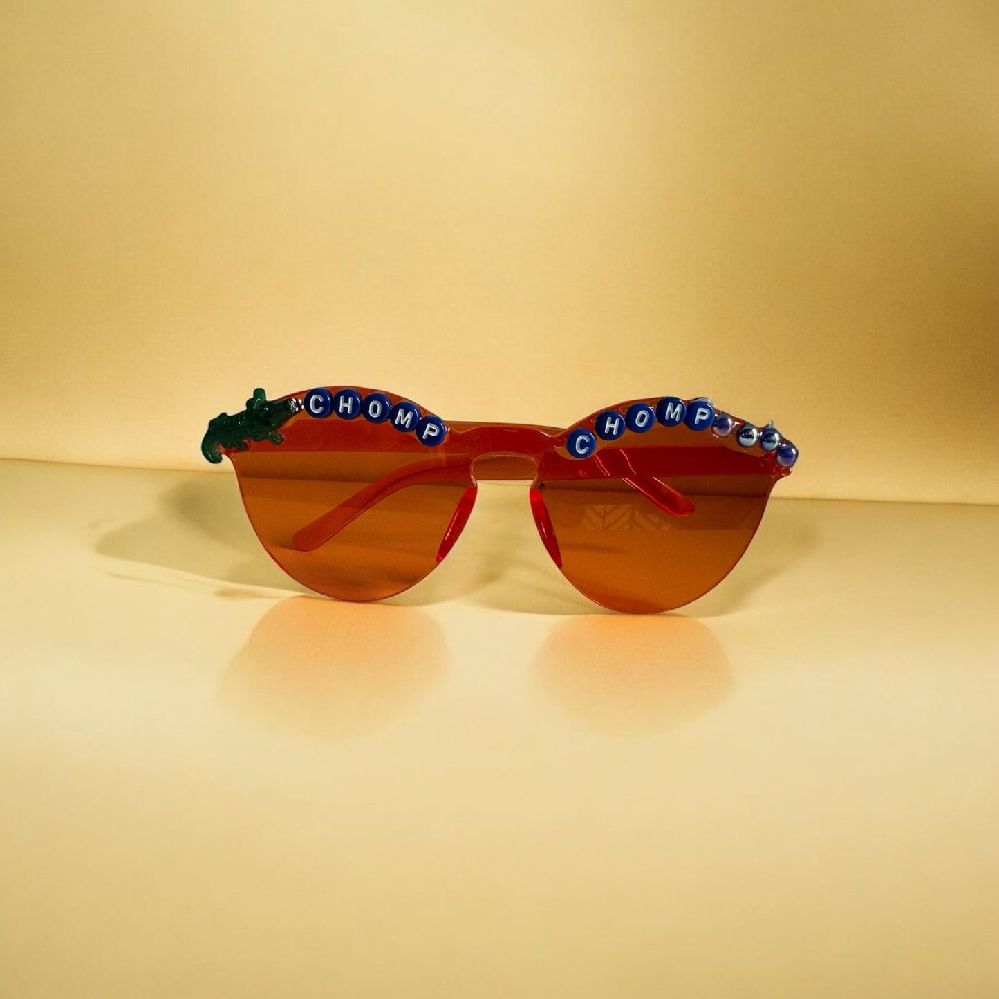 Round orange sunglasses with florida gators on the sides