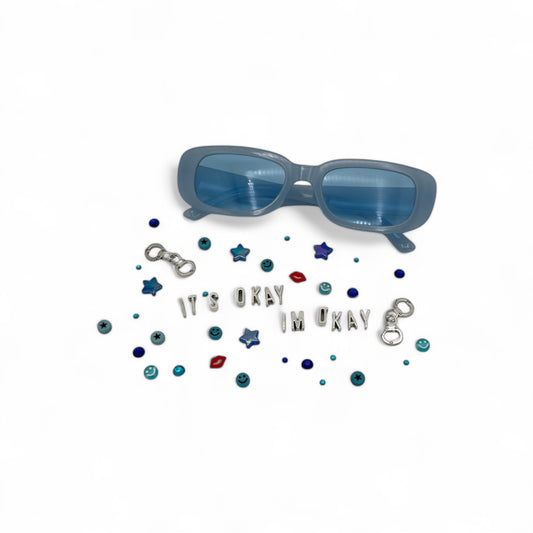 narrow blue rectangle sunglasses shown with charms