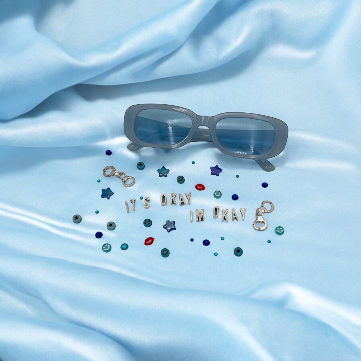 narrow blue rectangle sunglasses shown with charms