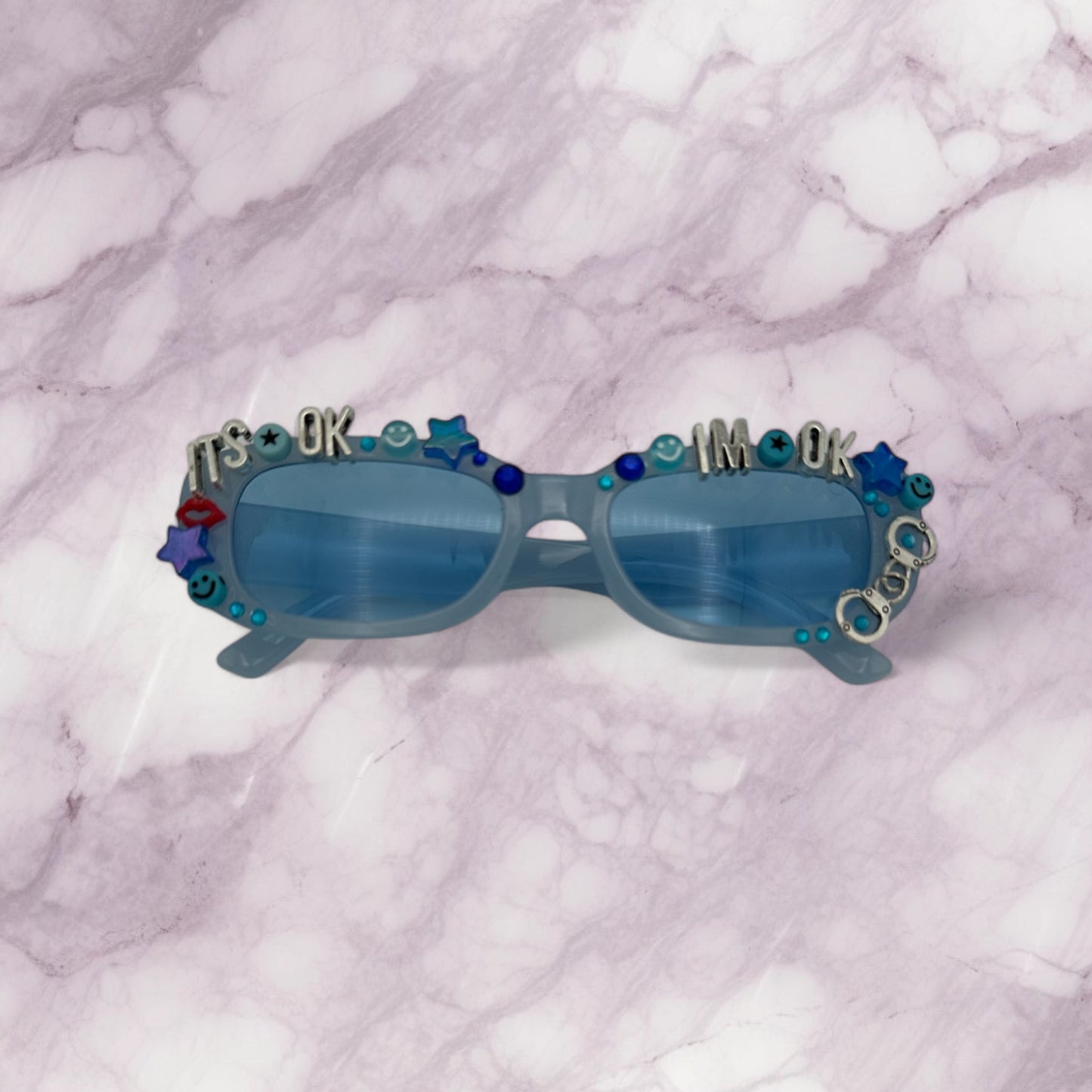 Blue narrow rectangle sunglasses with blue and silver charms