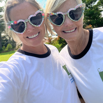 two women wearing camp bachelorette sunglasses