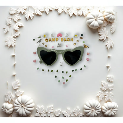 green heart sunglasses shown with charms around the frames