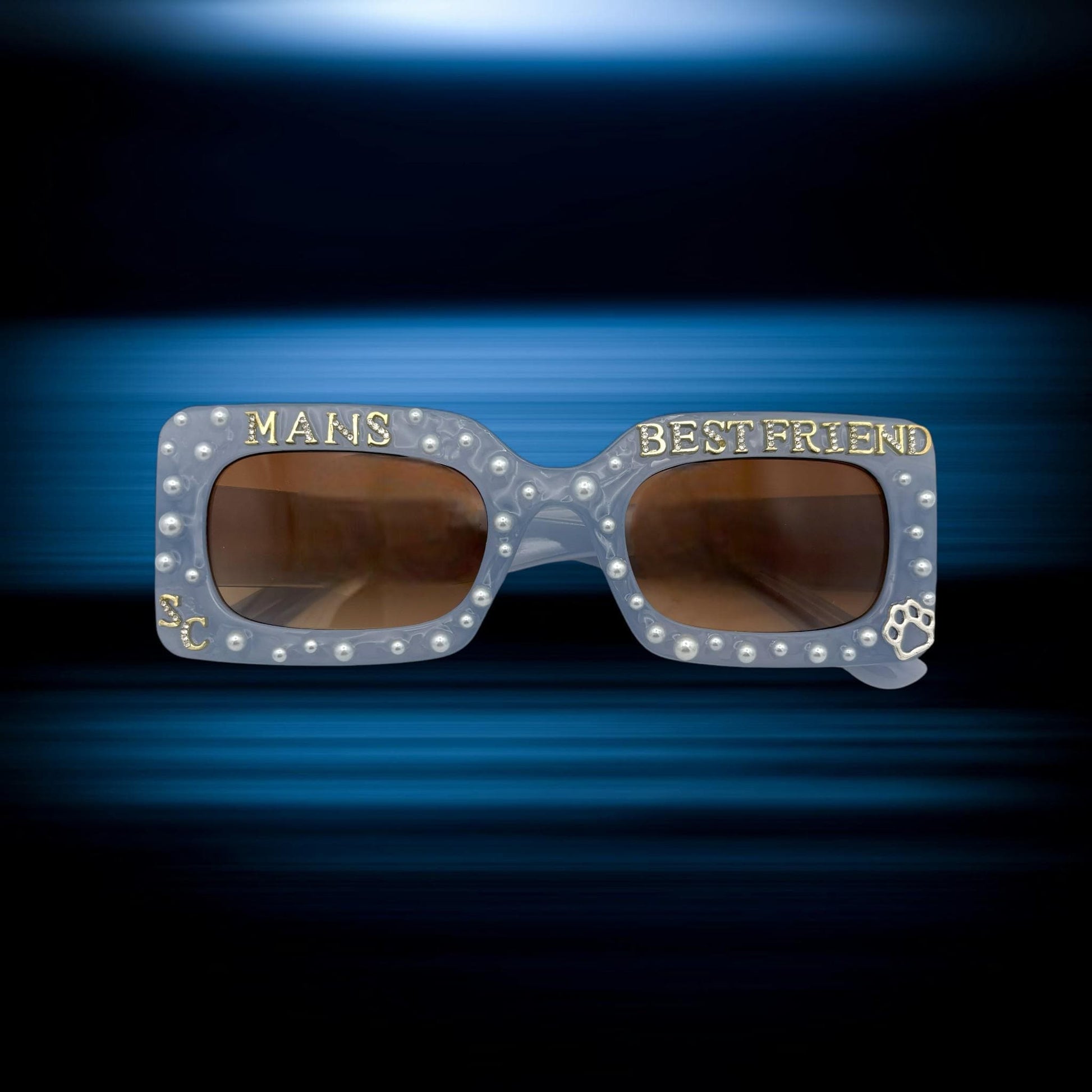 Sunglasses with 'MANS BEST FRIEND' text on a blue gradient background