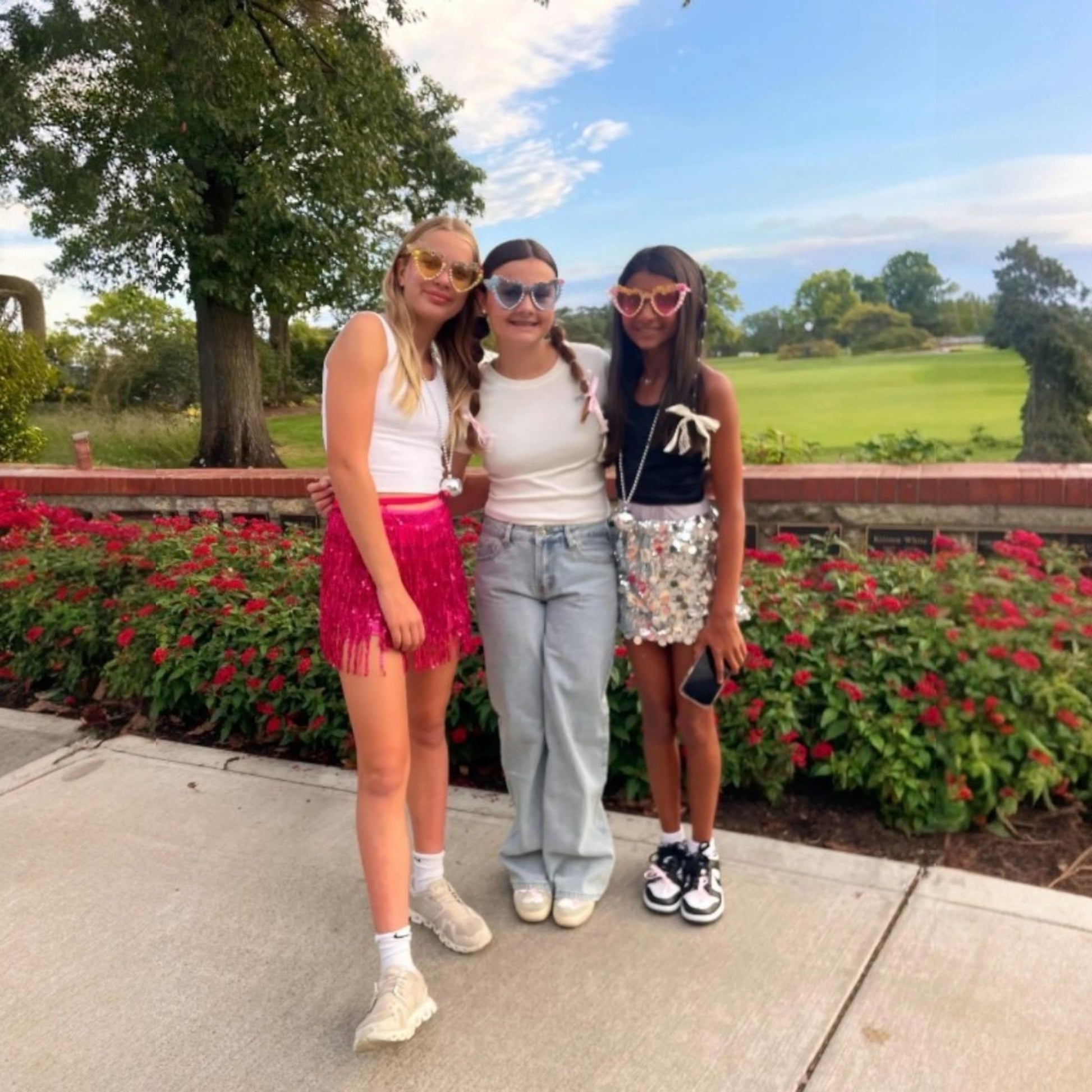 3 pre teen girls wearing sunglasses outside