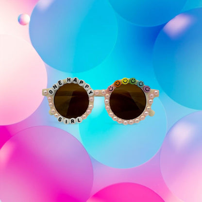 Round toddler sunglasses with pearls and smiley faces that say one happy girl