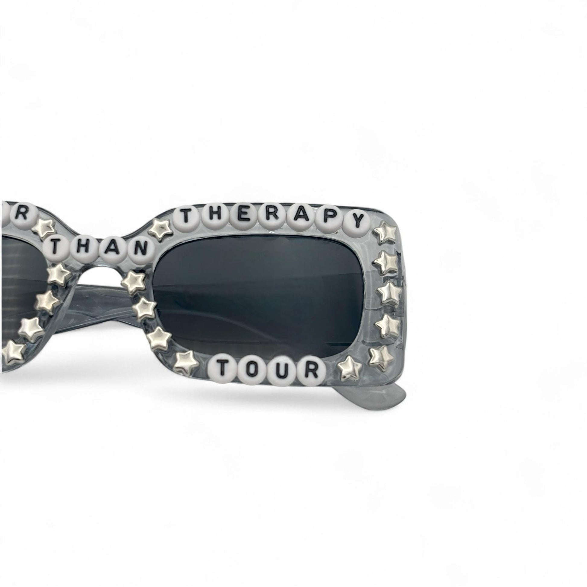 Sunglasses with decorative frame and text on a white background