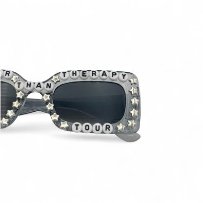 Sunglasses with decorative frame and text on a white background