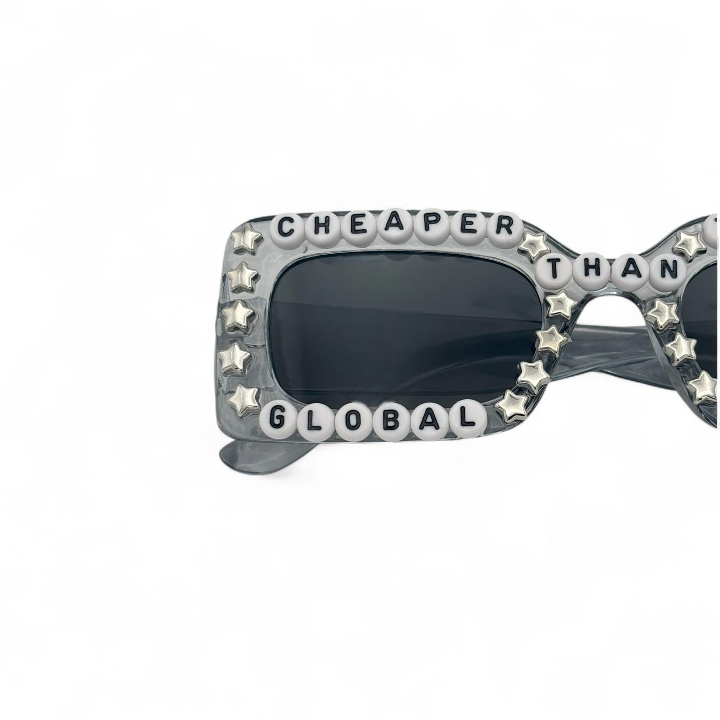 Sunglasses with star-shaped embellishments and text on a white background
