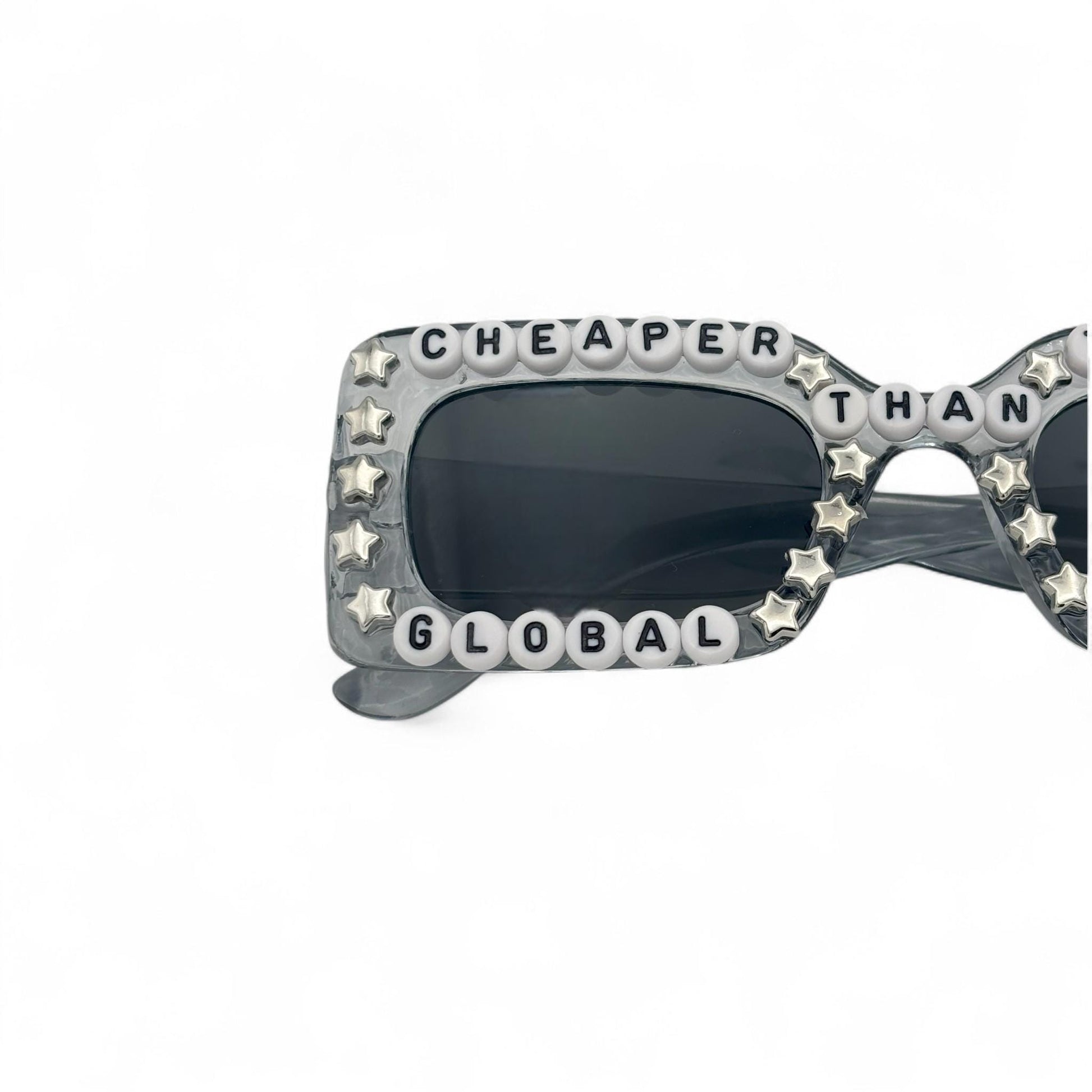 Sunglasses with star-shaped embellishments and text on a white background