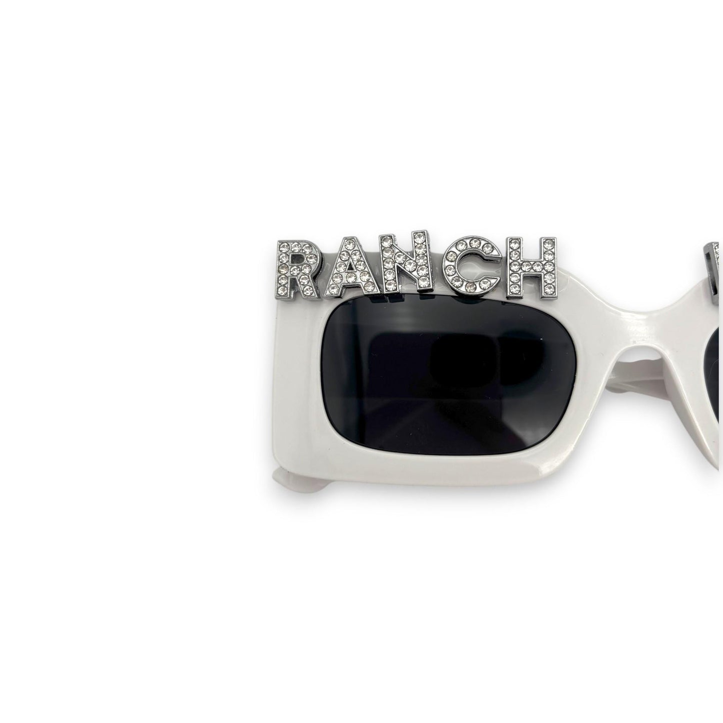 Sunglasses with 'RANCH' embellishment on a white background