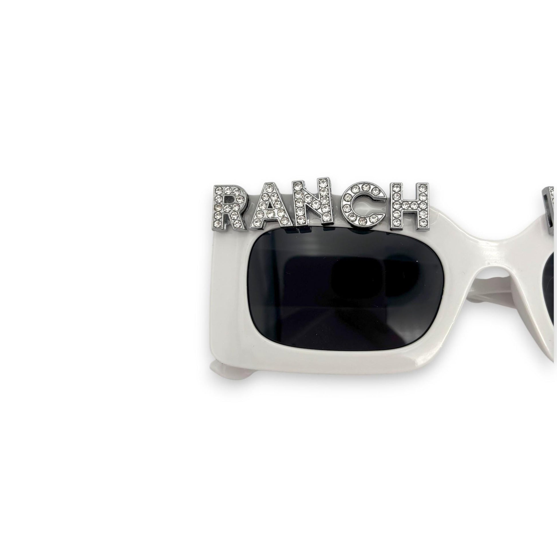 Sunglasses with 'RANCH' embellishment on a white background