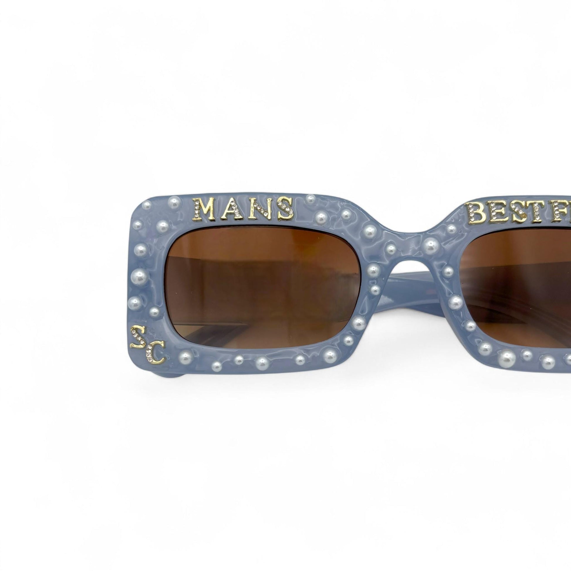 Sunglasses with decorative frame and text on a white background