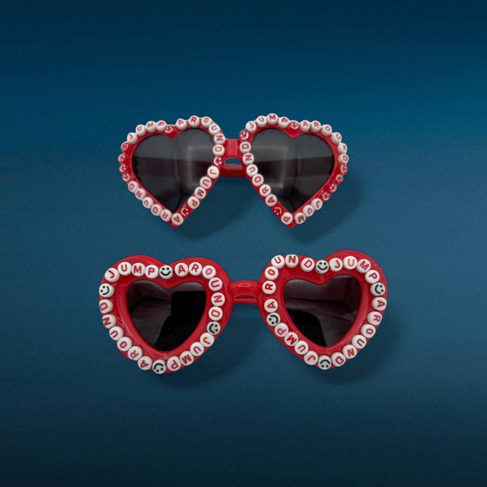 2 pair of red heart sunglasses that say jump around