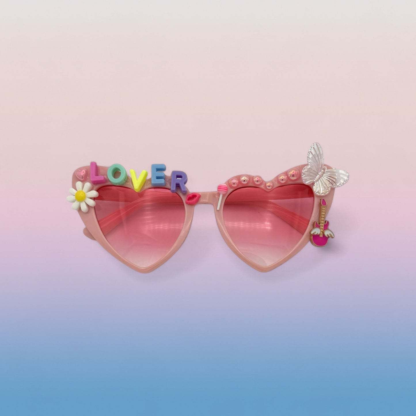 Pink heart sunglasses that have pastel charms and letters